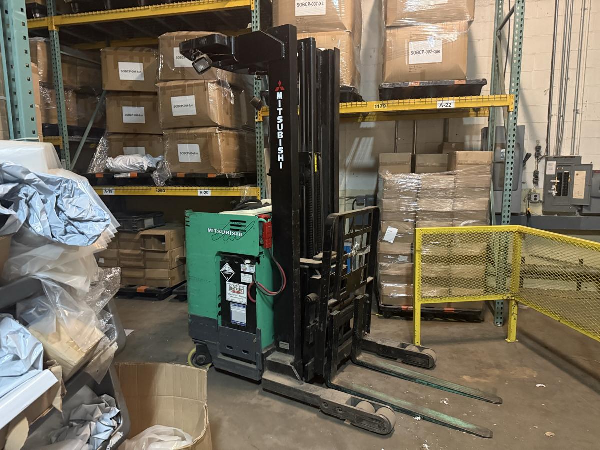 Forklift between pallet racks