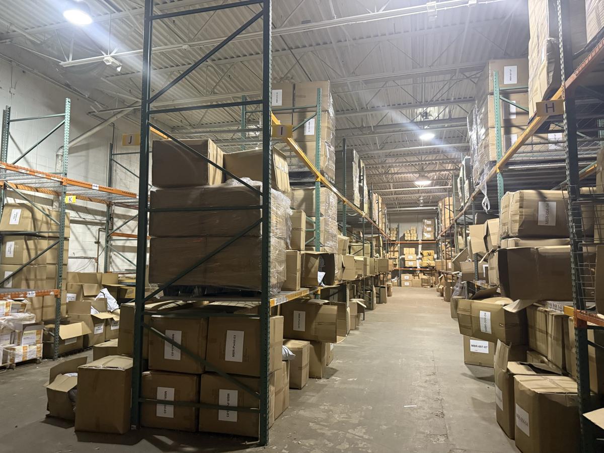 Labeled pallet racking stocked to the ceiling